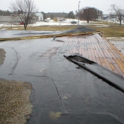 water pooling and wind damaged roof sproule